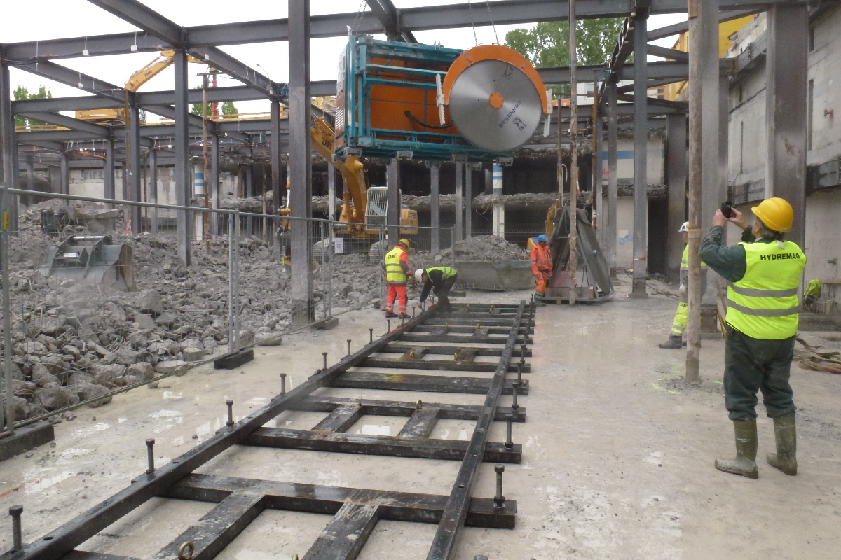 Thick concrete, poor access. Automated cutting is the answer Automated, and remotely controlled rail driven gantry for thick concrete slab demolition